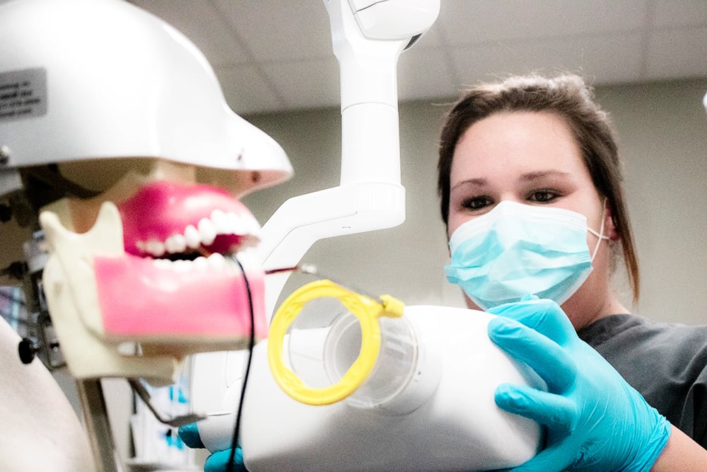 Dental Assisting student working with x-ray machine
