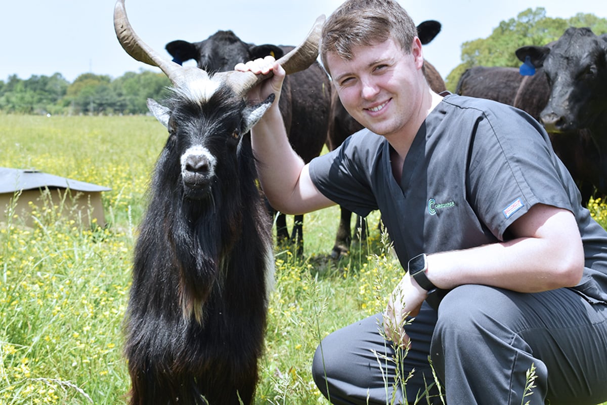 Caris College Veterinary Assisting student with goat in field