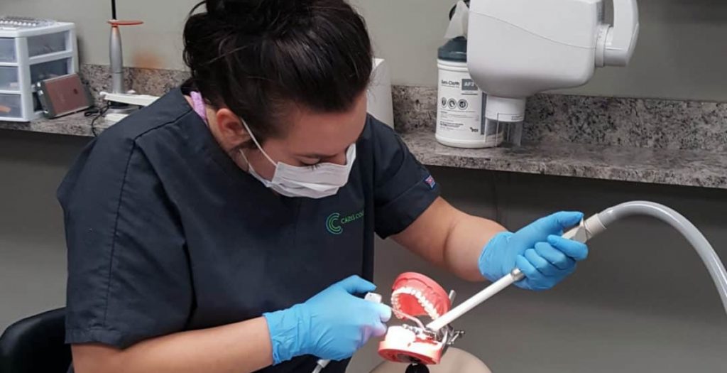 a dental assistant practicing work